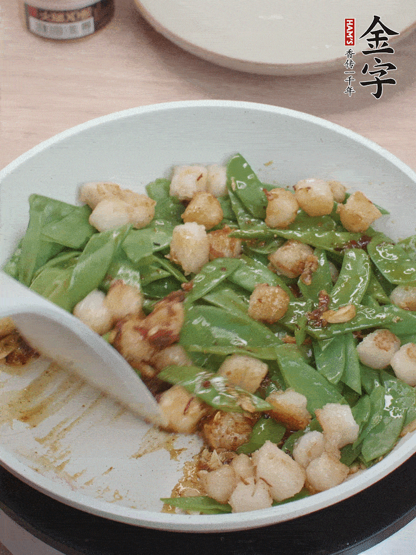 下甜豆莢、鮮貝輕輕翻炒均勻。