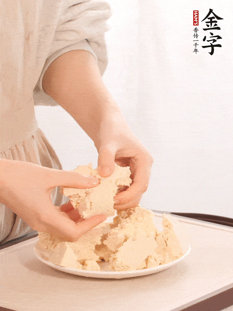 老豆腐用手掰成塊。